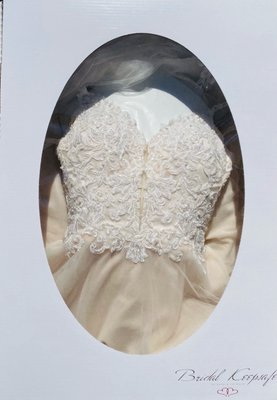 Wedding dress in preservation box. The dress is a blush tone (NOT discoloration from the cleaning/preservation process).