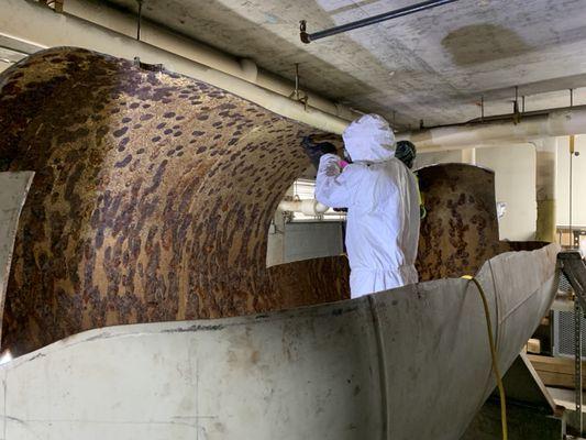 Demolition of an indoor building water tank.