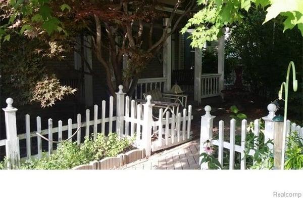 Private, treed, entry way surrounded by beautiful gardens.