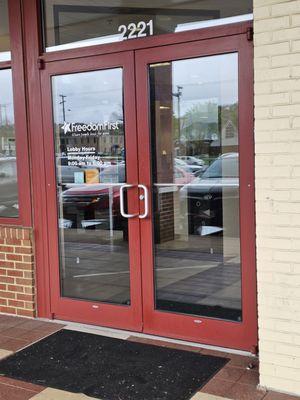 The doors to the Freedom First Credit Union branch at the Towers Mall Shopping Center.