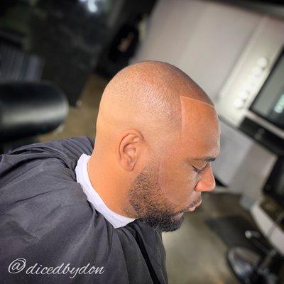 High bald fade and taper on the beard