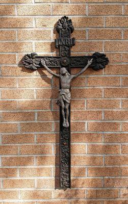 A Crucifix on the side of the Church – representing Jesus Christ giving Himself for our sins and thus, uniting us with God the Father.