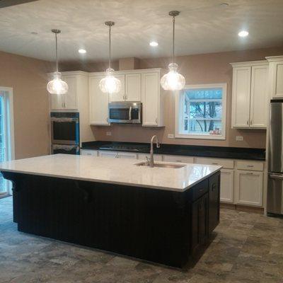 New pendant lighting and can lights in a kitchen remodeling project.