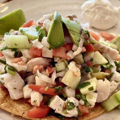 Taco de ceviche (fish, cucumbers, tomato, onion) with avocado and sour cream