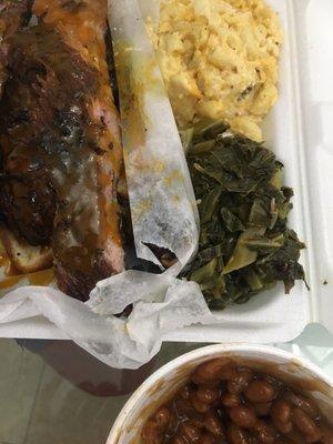 Ribs and chicken meal with macaroni and cheese and greens