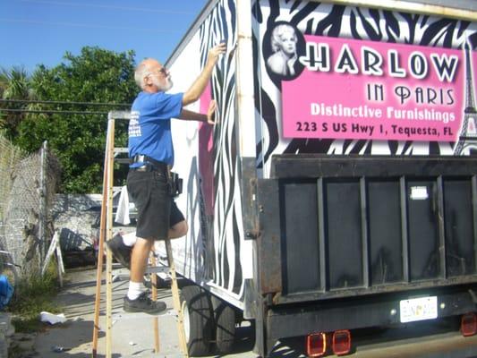 Mark Beaumont of Auto Art Vinyl Graphics installing box truck wrap for Harlow in Paris furniture consignments.