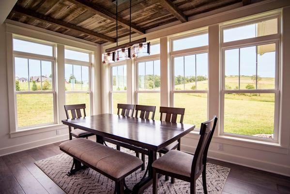 The EcoTek 3200 Series Double-Hung Windows with internal grids bring elegance and natural light to this dining room, enhancin...