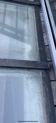 very sloppy silicone caulking that he never cleaned up on a skylight