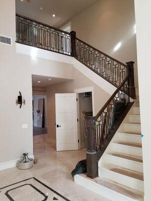 Alder custom rails/Caps and solid steps with paint grade skirtboards and custom iron balusters location Arcadia