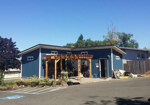 Entrance with pergola built by volunteers from sustainably harvested juniper lumber.