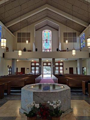 Interior - facing the back of the church. Upstairs is the choir loft. The stained glass window shows St. Theresa