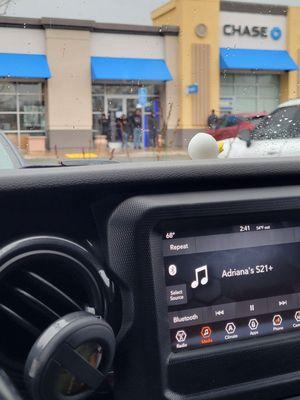 People waiting to use the one ATM in the rain!!!!