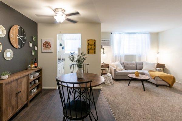 This is a picture of the dining area and living room in a 576 sq foot 1 bedroom, 1 bath apartment at Red Bank Reserve in the Madisonville ne