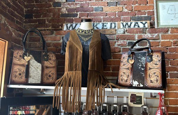 Hand-tooled leather bags and totes, leather fringe vests.