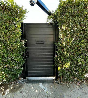 This was a beautiful wood and metal frame door built with a camera and a ring camera for extra security.