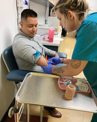 Student performing task in drawing blood.