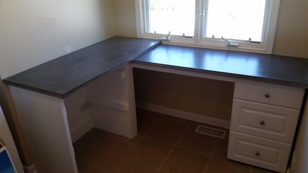 Custom built desk with concrete counters made by us.