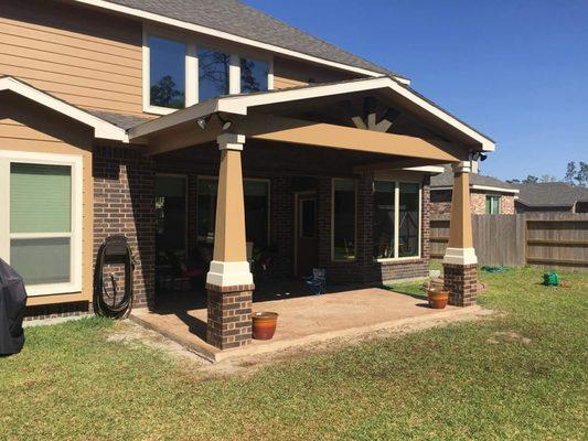 Covered patio addition with 1/3 brick columns located in Imperial Oaks