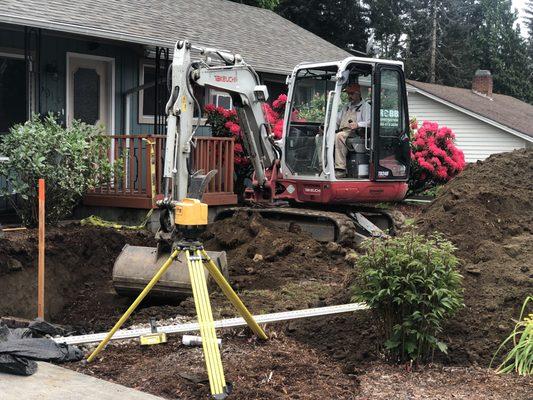 Installing a new septic system in a tight space.