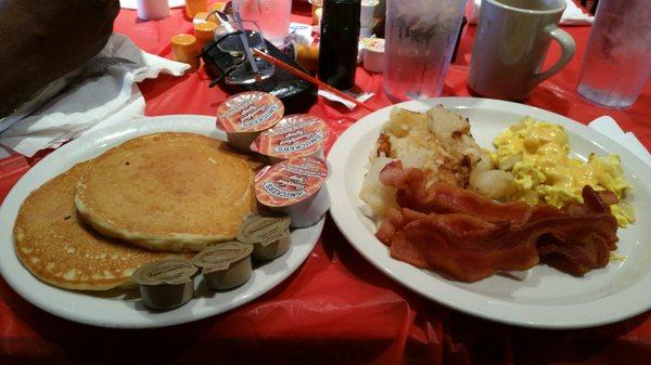 That kitchen table action! eggs with cheese and onion, fried potatoes , bacon & pancakes.