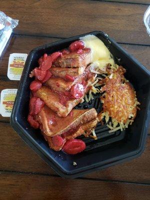 strawberry French toast with butter on the side and hashbrowns.