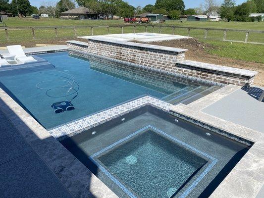 Raised brick wall with sheer descents and hot tub