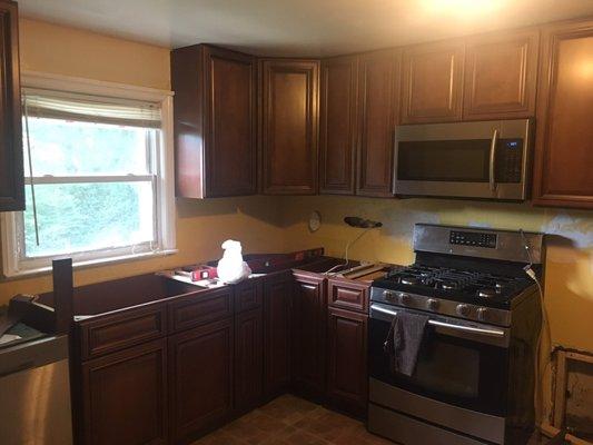 Small 10x9 kitchen not finished electrical or backsplash or floors yet.