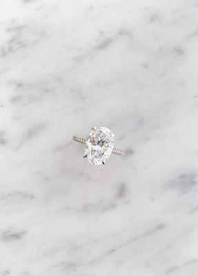 Elongated cushion cut diamond engagement ring hidden halo and delicate pavé setting