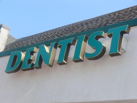 Dentist sign above building