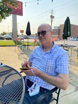 My husband at an outdoor table on the patio.