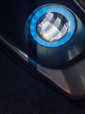 Nighttime photo of LED with Halo ring fog light on a Jeep Gladiator.