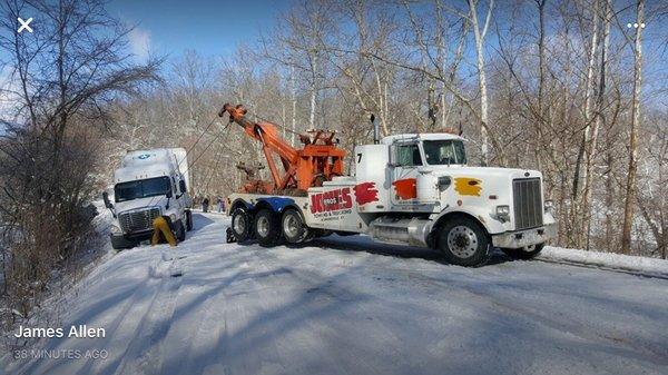 Heavy wrecker working in the snow