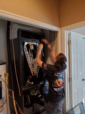 Jenn helping installing the air handler at her Mom's house. You have to be confident in your skills if you're going to do work for family.