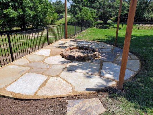 Flagstone with border & retaining wall against fence)