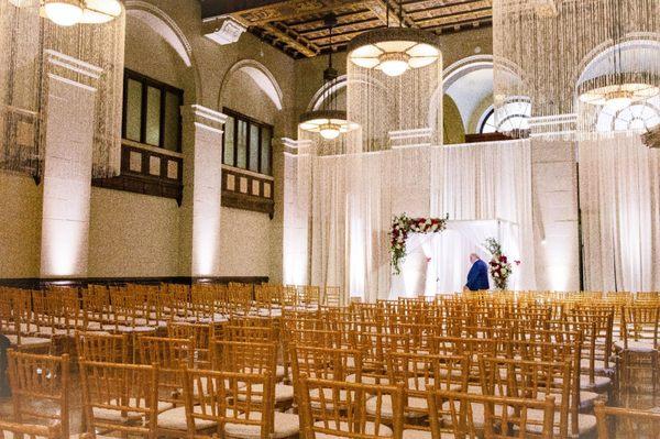 Wedding ceremony set up. Including drapery, chuppah, and uplighting from TeamImpulse.