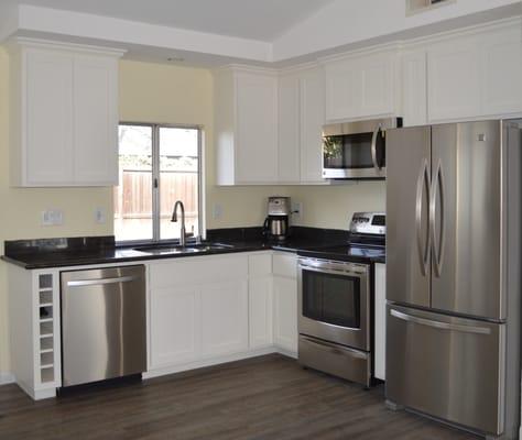 This kitchen has a mobile island to enhance it's functionality. The island creates a nook or a buffet style setting for a party.