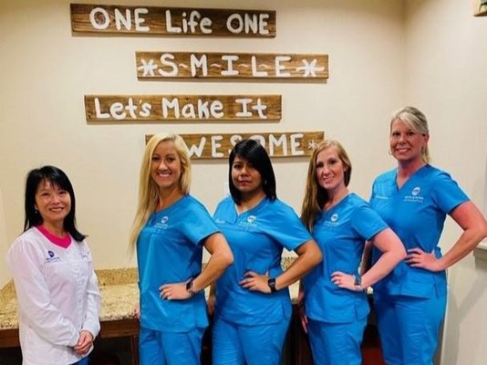 Happy Clients In Blue Scrubs