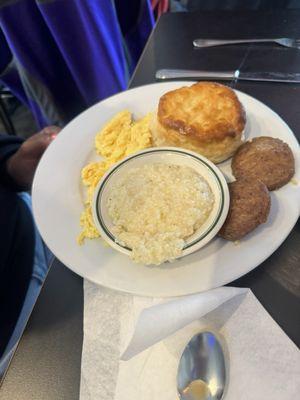 Eggs, grits, sausage patties, and biscuit