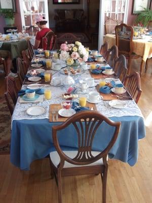 breakfast set up.  One large table, but many smaller (2-4 person) tables.  Always OJ & coffee & pastry.