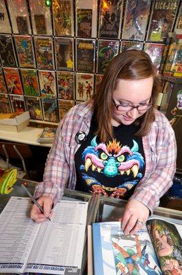 Owner Deanna ordering comics, making sure we have what you need!