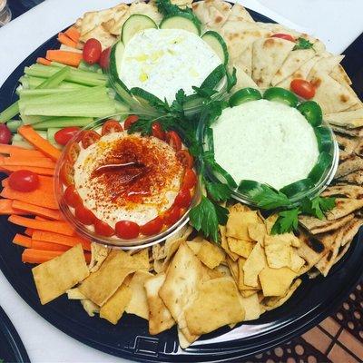 Homemade dip platter served with some veggies and pita bread!