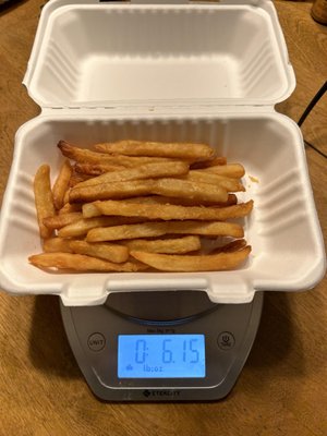 6 oz including the weight of the container. Not exactly 1 lb of fries