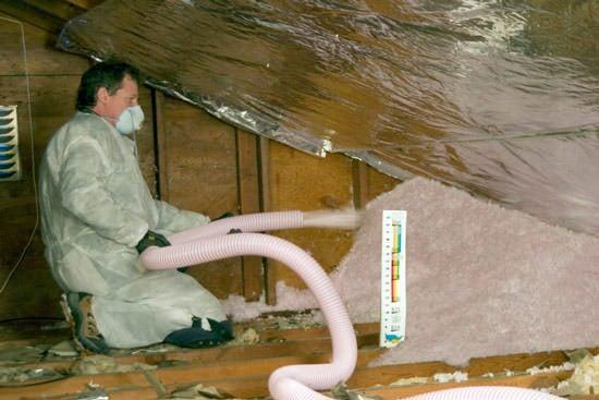 Blown in insulation being applied to an attic.