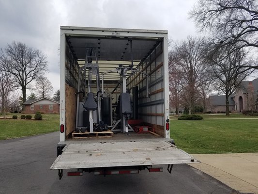 Loading of professional exercise equipment to donate to charity organization.