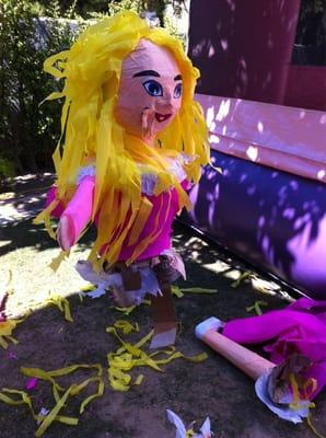 The left side of the inflatable princess castle and our piñata that sacrificed itself to spill its candy goodness.