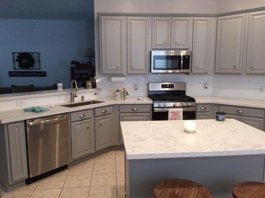 Beautiful kitchen update! New painted cabinets, new backsplash and new countertops.