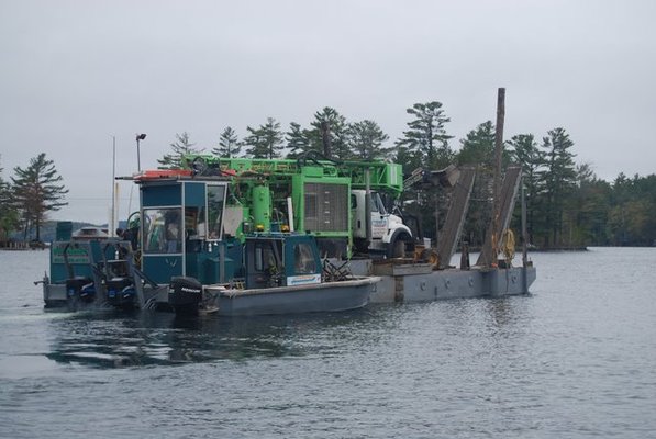 Drill rig being barged to an Island in Lake Winnipesaukee