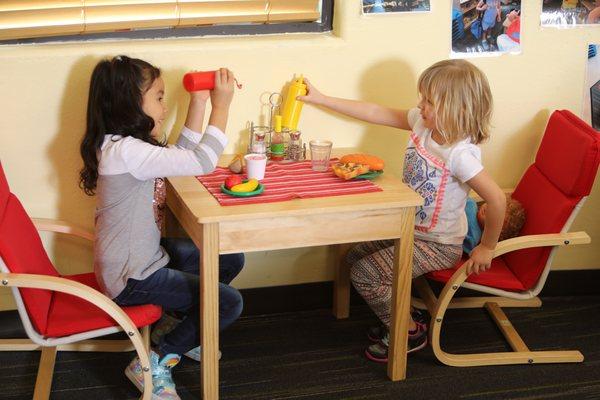 Kids enjoy imaginary play during open play.