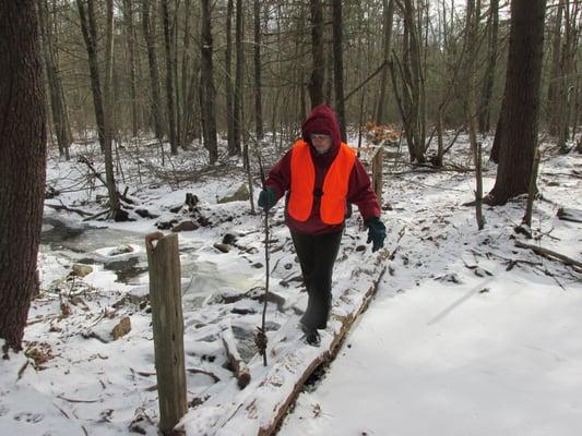 Scruffy person trying not to fall off scruffy bridge