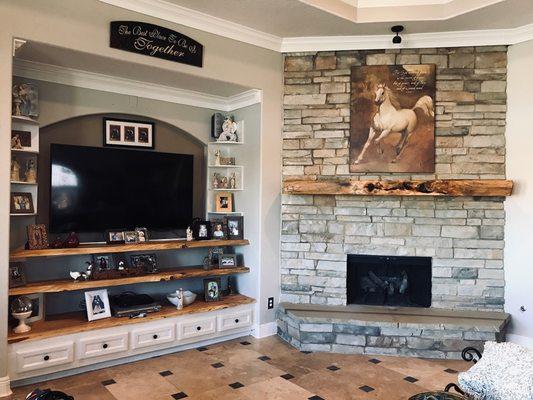 Installed the mantle and hearth on the fire place. I also installed custom cabinets and floating shelf's below the tv.